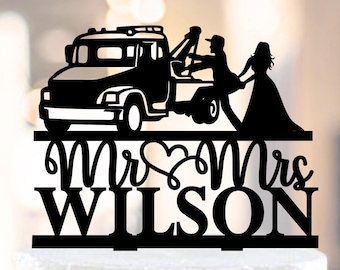 May include: Black silhouette of a tow truck with a couple holding hands, the bride in a wedding dress, and the groom in a suit. The text "Mr & Mrs WILSON" is below the image.