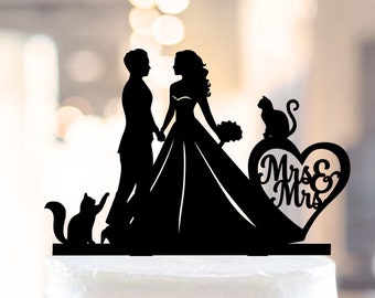 May include: Black silhouette cake topper featuring a bride and groom holding hands, two cats, and a heart with the text "Mrs & Mrs".