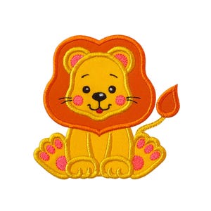 May include: A yellow lion applique with an orange mane and tail, and pink accents on the paws and cheeks. The lion is sitting, with a smiling expression and a small red tongue sticking out.