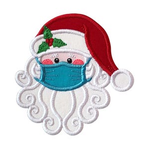 May include: An embroidered patch featuring the face of Santa Claus wearing a red hat with a white pom-pom and a green holly sprig. Santa has a thick white curly beard, rosy cheeks, and is wearing a teal blue face mask over the nose and mouth.