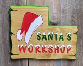 Christmas Santa&#39;s Workshop Hand Carved Wooden Sign | Rustic Holiday Santa Hat Door Decor