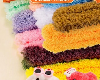 May include: A collection of 15mm coral fleece chenille pipes in various colours, including blue, brown, orange, yellow, and green. Two small, fuzzy dog figures are positioned in the foreground, one white with pink sunglasses and one red with a white bow.