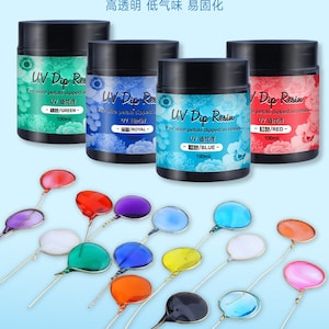 May include: Four bottles of UV resin for dipping wire petals in resin. The bottles are labeled with the colors green, royal blue, blue, and red. The bottles are 100 ml each. There are 14 small round glass beads on wire stems in various colors.