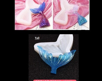 May include: Three silicone molds for making mermaid tail resin crafts. The molds are labeled "Big", "Small", and "Tail". The "Big" mold is 11.3 inches by 7.7 inches, the "Small" mold is 9 inches by 7 inches, and the "Tail" mold is 13 inches by 9 inches. The molds are shown with finished resin mermaid tails.