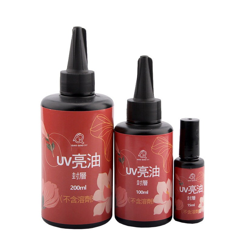 May include: Three bottles of UV resin, labeled "UV 亮油" in Chinese characters, with the text "封層" meaning "sealing layer" and the volume in milliliters. The bottles are red with a floral design and black caps.