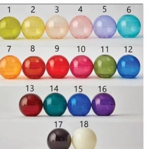 May include: A grid of eighteen colorful, transparent spheres. The spheres are arranged in rows and columns, each with a different hue, including yellow, pink, blue, and green. Numbers 1-18 are printed above each sphere.