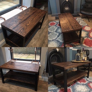 May include: A dark stained wooden coffee table with a lower shelf. The table has a rectangular top and is supported by black metal legs. The wood grain is visible. The table is approximately 48 inches long and 20 inches wide.