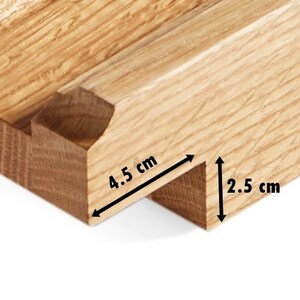 May include: Close-up of a wooden joint, showcasing a mortise and tenon construction. The tenon measures 4.5 cm in length and 2.5 cm in height. The wood has a natural, light brown color and visible grain.