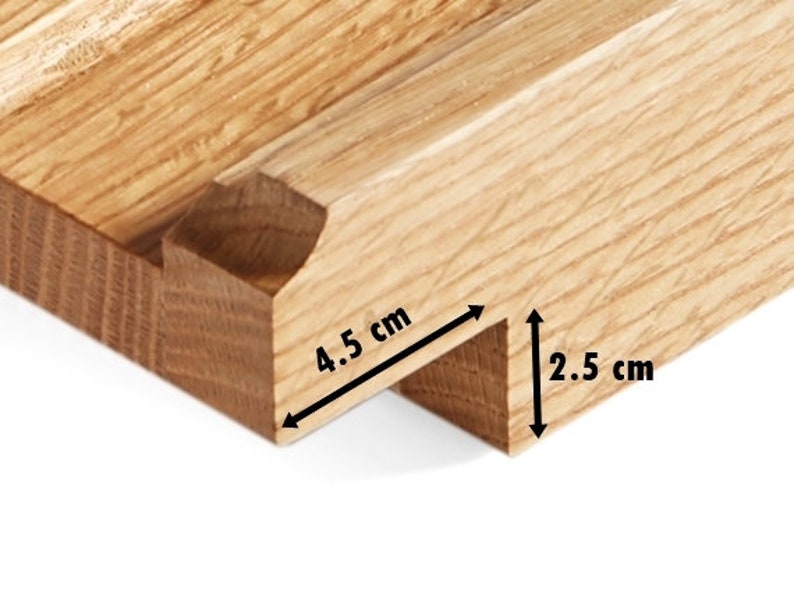 May include: Close-up of a wooden joint, showcasing a mortise and tenon construction. The tenon measures 4.5 cm in length and 2.5 cm in height. The wood has a natural, light brown color and visible grain.