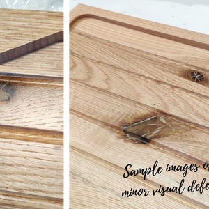 May include: Close-up of a light-colored wooden cutting board with a juice groove and a handle. The wood grain is visible, and the board has a natural, rustic appearance. The text "Sample images of minor visual defect" is written in black cursive.