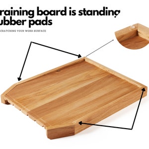 May include: A wooden draining board with a rectangular shape and a light brown color. The board has a slatted design on one side and is designed to stand on rubber pads. Text on the image reads: "Draining board is standing rubber pads. NOT SCRATCHING YOUR WORK SURFACE."
