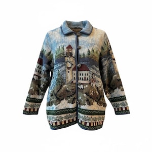 May include: Button-up jacket with a scenic landscape design featuring lighthouses, trees, and buildings. The jacket has a light blue collar and trim, with a color palette of blues, greens, and browns. The jacket has long sleeves and two pockets.