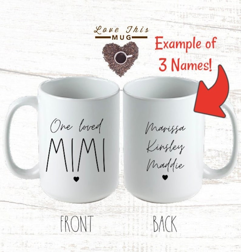 May include: White ceramic mug with a black heart and the text "One loved MIMI" on the front. The back of the mug has the text "Marissa Kinsley Maddie" on it.