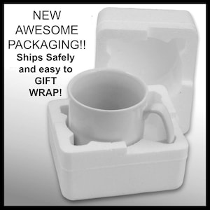 May include: A white ceramic mug with a handle is nestled in a white styrofoam packaging. The packaging is designed to protect the mug during shipping and makes it easy to gift wrap.