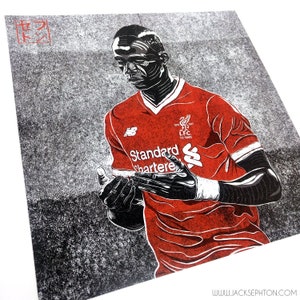 May include: Black and white illustration of a soccer player wearing a red jersey with the text "Standard Chartered" and the Liverpool Football Club logo. The player is holding a soccer ball in his hands.