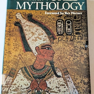 May include: A hardcover book titled Encyclopedia of World Mythology with a foreword by Rex Warner. The cover features a profile illustration of an Egyptian figure wearing a tall white and green headdress, with hieroglyphics on a textured gold background.
