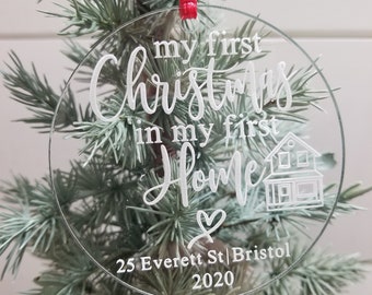 May include: Clear glass Christmas ornament with the text "my first Christmas in my first Home" and a small house illustration. The ornament also includes the text "25 Everett St | Bristol 2020".