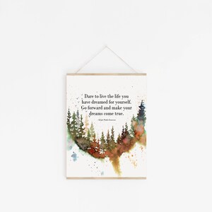 May include: A watercolor print with a quote about living the life you dream: "Dare to live the life you have dreamed for yourself. Go forward and make your dreams come true." The quote is surrounded by a watercolor painting of a forest.