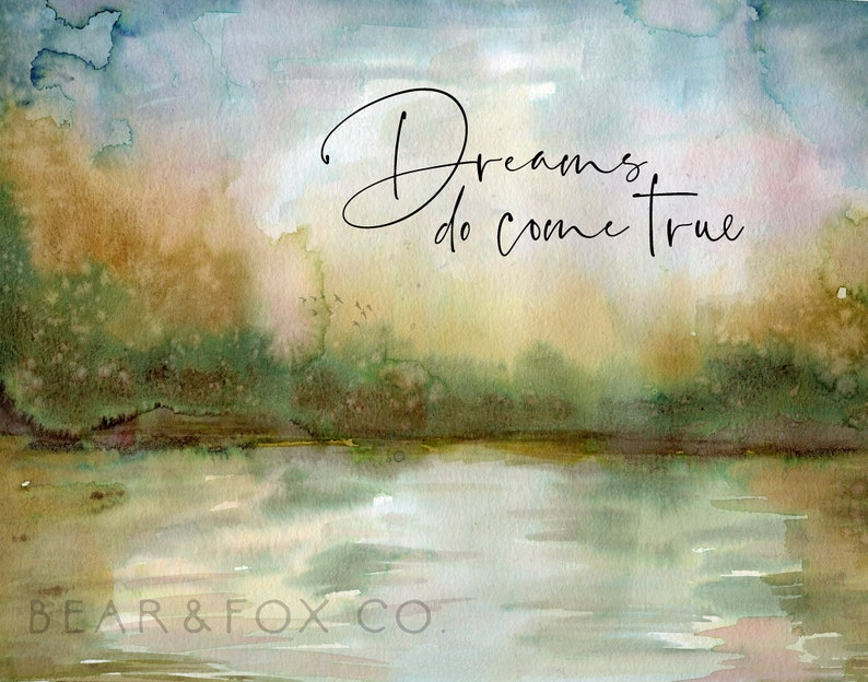 May include: Watercolor painting of a forest scene with a lake in the foreground. The sky is a soft blue and the trees are a mix of green and brown. The text "Dreams do come true" is written in black cursive script.