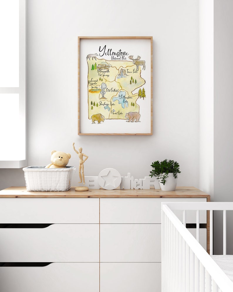 May include: A watercolor illustration of Yellowstone National Park, featuring landmarks like Old Faithful, Yellowstone Lake, and Tower Fall. The illustration is surrounded by a brown frame and includes images of a bison, a bear, and an elk.