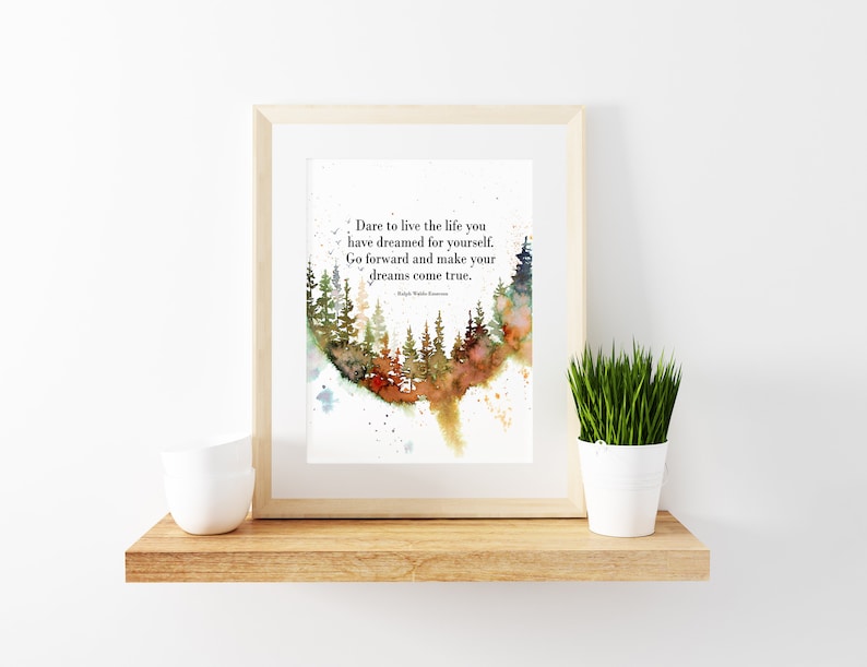 May include: A framed watercolor painting of a forest with a quote about living the life you dream. The quote reads: "Dare to live the life you have dreamed for yourself. Go forward and make your dreams come true." The quote is attributed to Ralph Waldo Emerson.