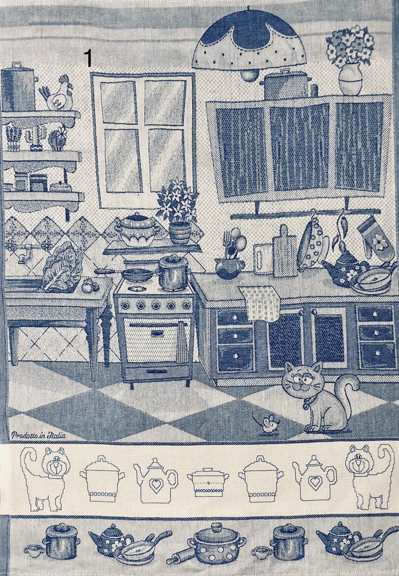 May include: A blue and white kitchen themed tea towel with a cat, a mouse, and a variety of kitchen utensils. The towel has a checkered pattern and the text "Prodotto in Italia" at the bottom.