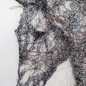 May include: A black and white line drawing of a horse's head, created with a tangled web of thread. The horse's eye is visible, and the lines create a sense of movement and energy.