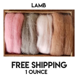May include: A wooden box filled with four bundles of lamb wool in shades of pink, gray, off-white, and brown. The word "LAMB" is printed above the box.