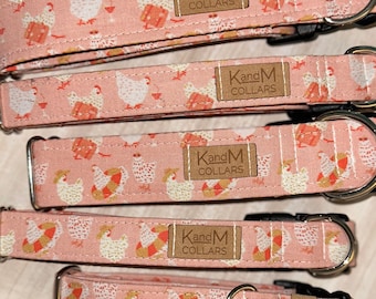 May include: Five pink dog collars with a white chicken print and brown "KandM Collars" label. The collars are arranged in a stack from largest to smallest.