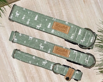 May include: Three green dog collars with a white reindeer and pine tree pattern. The collars have a brown leather tag that says "KangM Collars".