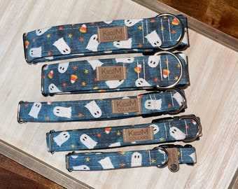 May include: Four blue and white dog collars with a ghost and candy corn pattern. The collars have a brown label that says "KandM Collars".