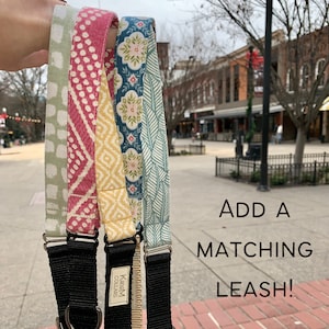 May include: Four different patterned dog collars with black adjustable straps and metal hardware. The collars are made of fabric and have a variety of colours and patterns, including green, red, yellow, and blue. The text "Kadim Collars" is visible on one of the collars. The text "ADD A MATCHING LEASH!" is visible in the bottom right corner of the image.