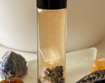 Perfume Hoodoo com infusão de cristais para atrair dinheiro