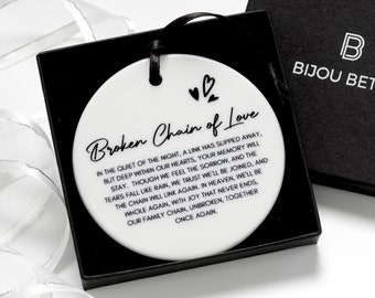 May include: White ceramic ornament with a black inscription that reads "Broken Chain of Love" and a poem about remembering a loved one. The ornament is packaged in a black box with the words "Bijou Betty" printed on the top.