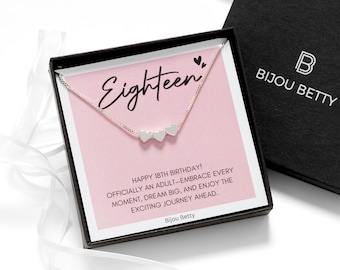 May include: A silver-toned necklace with three small heart charms displayed in a black gift box. The insert features the text Eighteen, Happy 18th Birthday! Officially an adult—embrace every moment, dream big, and enjoy the exciting journey ahead.