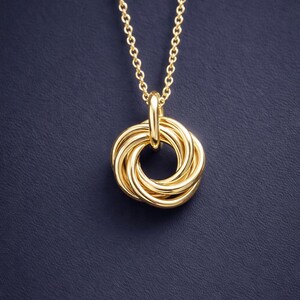 Close up of 50th birthday interlinked 5 ring necklace in 14k gold finish