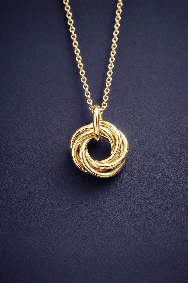 Close up of 50th birthday interlinked 5 ring necklace in 14k gold finish