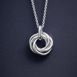 Close up of a silver 50th birthday necklace.