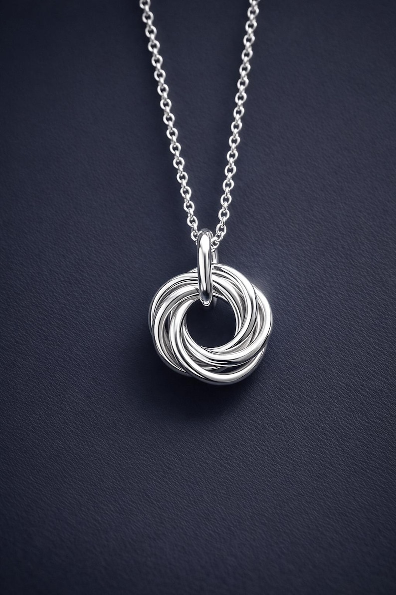 Close up of a silver 50th birthday necklace.