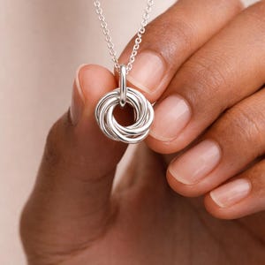 Close up of a 50th birthday silver necklace.