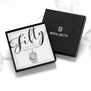 A silver plated necklace with a five-ring pendant in a luxury gift box, perfect for daughter.