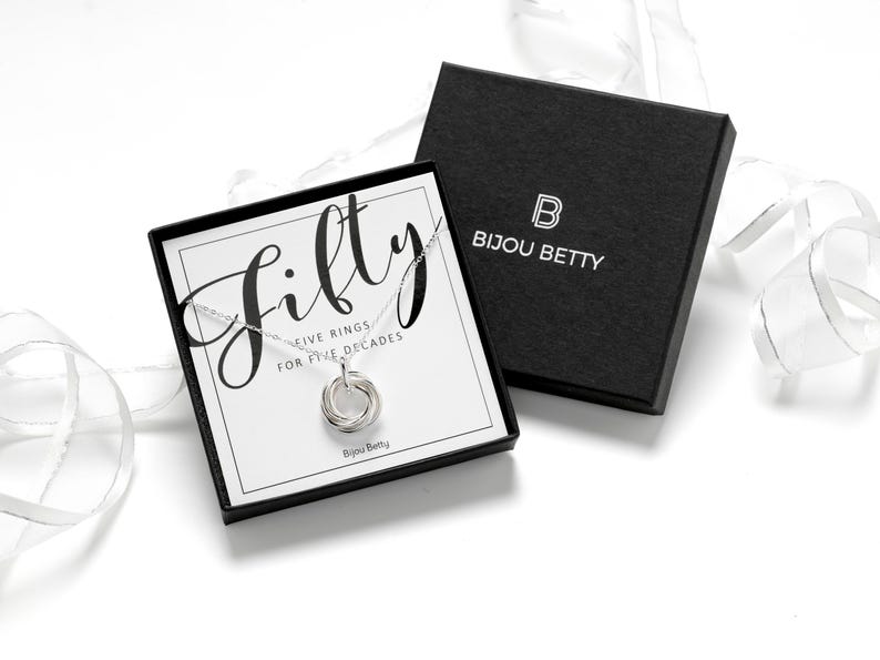 A silver plated necklace with a five-ring pendant in a luxury gift box, perfect for daughter.