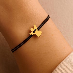 A model wearing a stainless steel angel on a black cord bracelet, perfect for sympathy or birthday gifts.