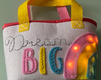 Lit-up child’s hand bag.  Battery-powered LED fairy lights on fun embroidered child’s purse.