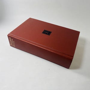 May include: A red hardcover book with the title "Indian Jones" and the author "Henry Morton Robinson" printed on the spine. The book has a black and white illustration of a person on the front cover.