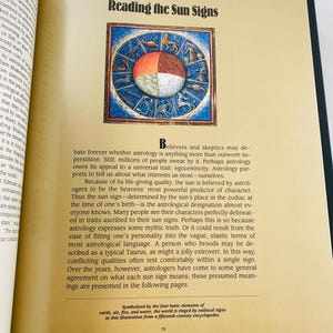 May include: Open book page with the title "Reading the Sun Signs" above a colorful illustration of the zodiac. The illustration is a circle divided into sections with astrological symbols and figures. Text discusses astrology and sun signs.