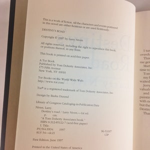 May include: A book cover for "Destiny's Road" by Larry Niven. The cover is a dark blue with a white title and author name. The copyright date is 1997.