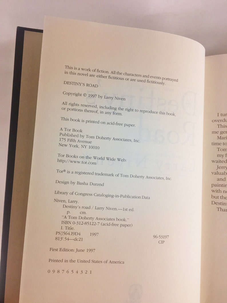 May include: A book cover for "Destiny's Road" by Larry Niven. The cover is a dark blue with a white title and author name. The copyright date is 1997.