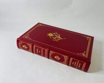 May include: A burgundy book with gold floral detailing and text. The spine reads "PINEL ON INSANITY" and "THE CLASSICS OF MEDICINE LIBRARY". The cover features a gold floral design.