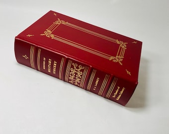 May include: A red leather-bound book with gold lettering on the spine. The title is "The Classics of Military Surgery" by P.J. Larrey. The book is part of The Classics of Medical Library.